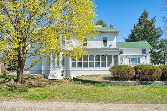 11811 Laird Rd, Brooklyn, MI 49230 - view of front facade with a front lawn, roof with shingles, and a chimney