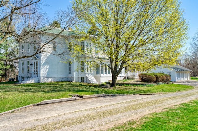 11811 Laird Rd, Brooklyn, MI 49230 - view of side of home featuring an outbuilding, a yard, and a garage