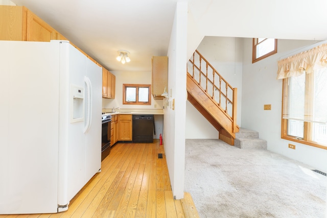 11811 Laird Rd, Brooklyn, MI 49230 - kitchen with white fridge with ice dispenser, range, light countertops, light wood-type flooring, and dishwasher