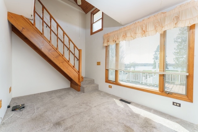11811 Laird Rd, Brooklyn, MI 49230 - unfurnished living room with visible vents, stairs, and carpet flooring