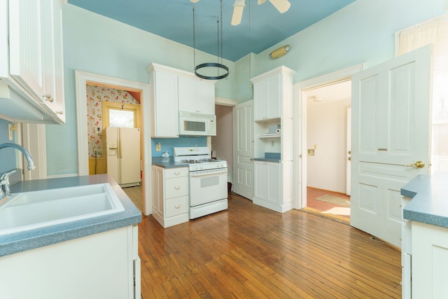 11811 Laird Rd, Brooklyn, MI 49230 - kitchen with white cabinetry, white appliances, dark wood finished floors, and a sink