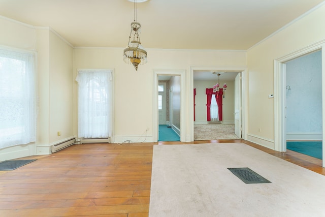 11811 Laird Rd, Brooklyn, MI 49230 - spare room with baseboard heating, visible vents, hardwood / wood-style flooring, and ornamental molding