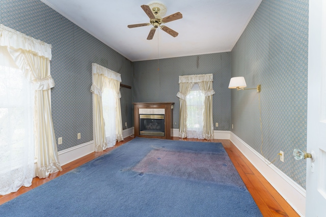 11811 Laird Rd, Brooklyn, MI 49230 - unfurnished living room with a glass covered fireplace, a ceiling fan, ornamental molding, hardwood / wood-style floors, and wallpapered walls