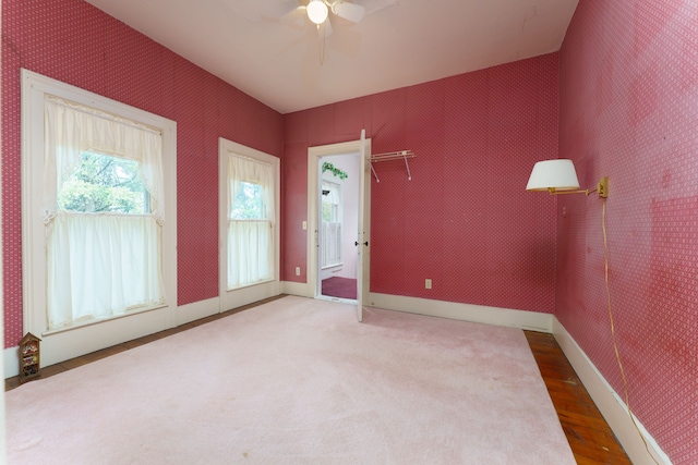 11811 Laird Rd, Brooklyn, MI 49230 - spare room featuring a ceiling fan, wallpapered walls, wood finished floors, and baseboards
