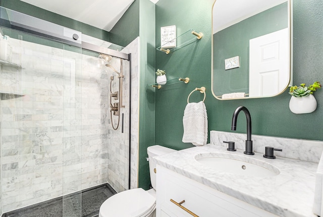 bathroom with vanity, toilet, and a stall shower