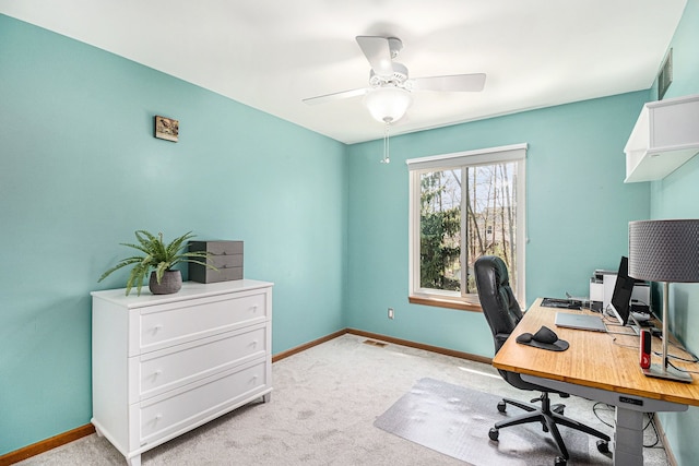 office featuring ceiling fan, baseboards, visible vents, and light carpet