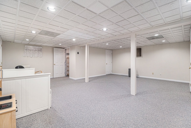finished below grade area featuring recessed lighting, light colored carpet, and baseboards