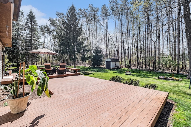 deck featuring an outbuilding, a shed, outdoor dining area, and a yard