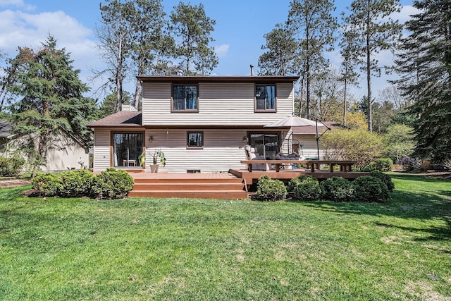 back of property featuring a lawn and a deck