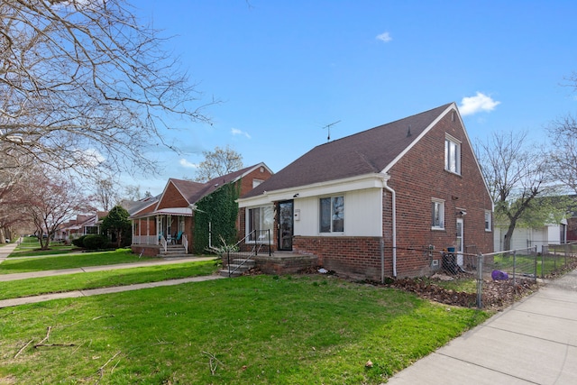 6545 Asbury Park, Detroit, MI 48228 - view of front facade with brick siding, fence, and a front lawn