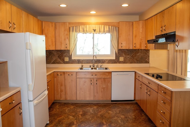 kitchen featuring decorative backsplash, a sink, light countertops, under cabinet range hood, and white appliances