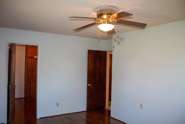 spare room featuring baseboards, a ceiling fan, and wood finished floors