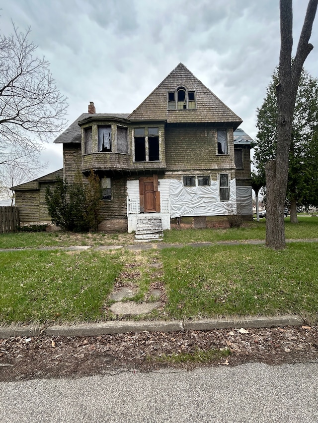view of front of home with a front lawn and a chimney