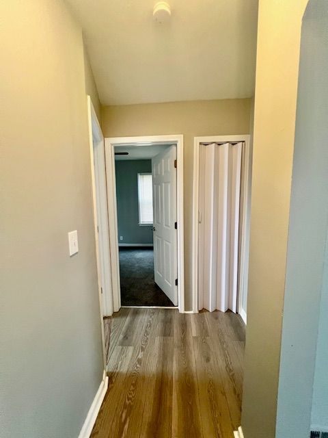19676 Kingsville St, Harper Woods, MI 48225 - corridor with baseboards and wood finished floors