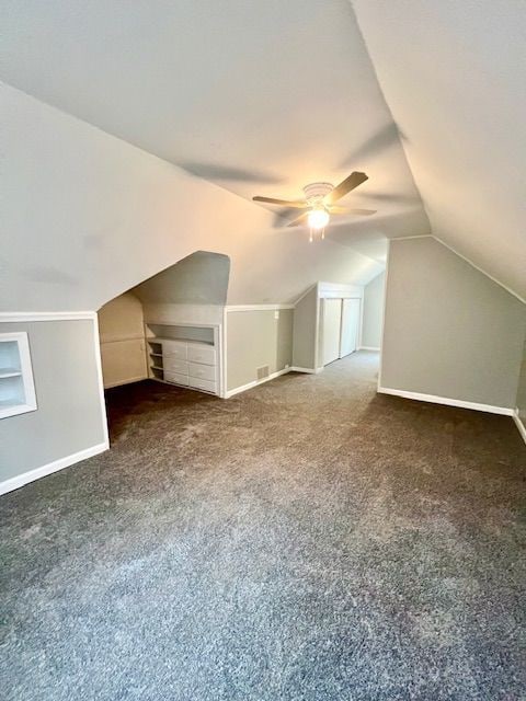 19676 Kingsville St, Harper Woods, MI 48225 - additional living space with ceiling fan, vaulted ceiling, baseboards, and carpet flooring