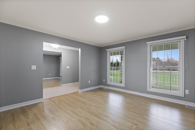 5580 Hegel Rd, Goodrich, MI 48438 - spare room with baseboards, a wealth of natural light, crown molding, and visible vents