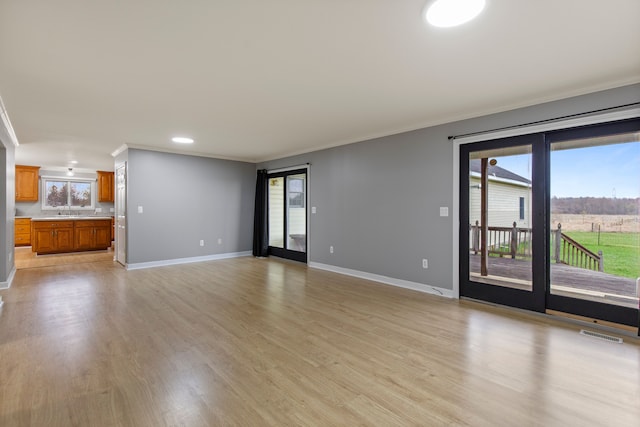 5580 Hegel Rd, Goodrich, MI 48438 - unfurnished living room featuring visible vents, recessed lighting, crown molding, light wood finished floors, and baseboards