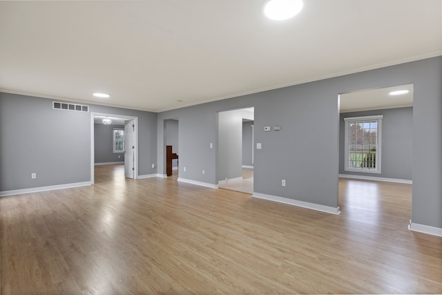 5580 Hegel Rd, Goodrich, MI 48438 - unfurnished living room with baseboards, ornamental molding, visible vents, and light wood-style floors