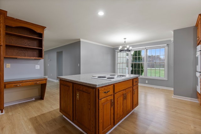 kitchen with light wood finished floors, baseboards, white electric stovetop, and a notable chandelier
