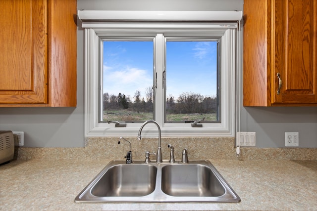 5580 Hegel Rd, Goodrich, MI 48438 - kitchen featuring a sink, light countertops, and brown cabinets
