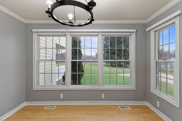 5580 Hegel Rd, Goodrich, MI 48438 - unfurnished dining area featuring an inviting chandelier, crown molding, light wood-type flooring, and visible vents