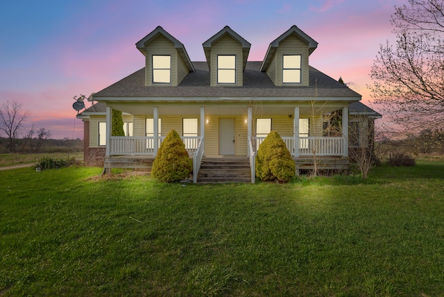 5580 Hegel Rd, Goodrich, MI 48438 - cape cod house with a shingled roof, a porch, and a lawn