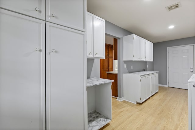 5580 Hegel Rd, Goodrich, MI 48438 - kitchen with white cabinets, light wood-type flooring, visible vents, light countertops, and recessed lighting