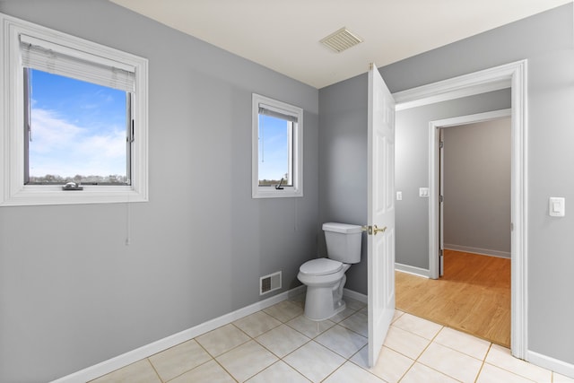 5580 Hegel Rd, Goodrich, MI 48438 - bathroom featuring tile patterned flooring, toilet, baseboards, and visible vents