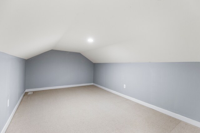 5580 Hegel Rd, Goodrich, MI 48438 - additional living space with visible vents, recessed lighting, vaulted ceiling, light carpet, and baseboards
