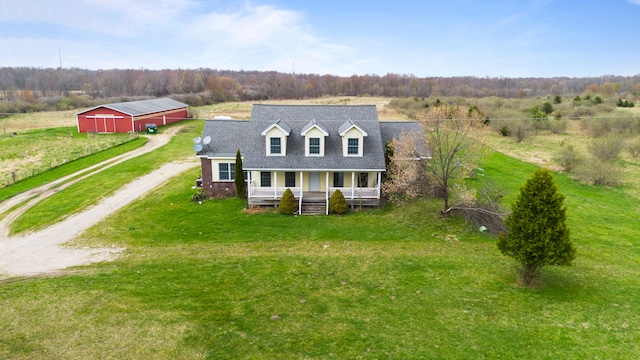 5580 Hegel Rd, Goodrich, MI 48438 - cape cod house featuring dirt driveway, an outdoor structure, a pole building, covered porch, and a front yard