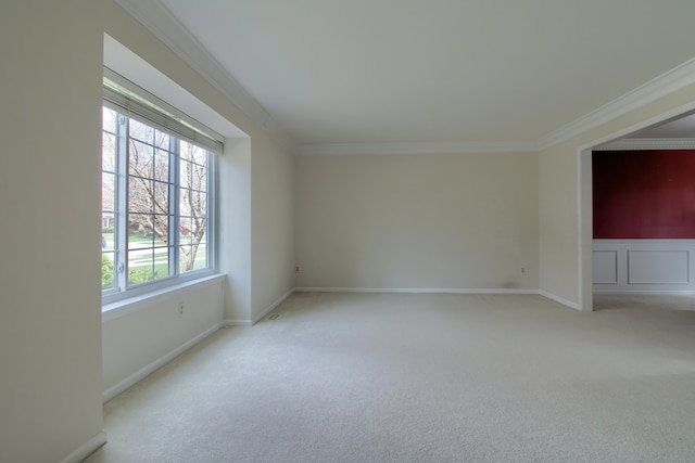 carpeted spare room featuring ornamental molding