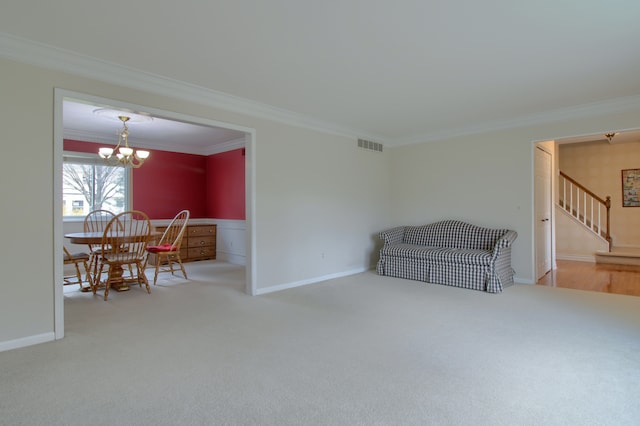 interior space featuring carpet, visible vents, ornamental molding, a chandelier, and stairs