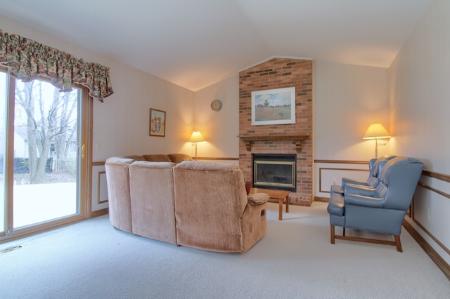 carpeted living room with lofted ceiling, a brick fireplace, and visible vents