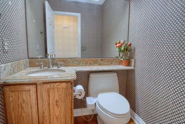 half bathroom with toilet and vanity