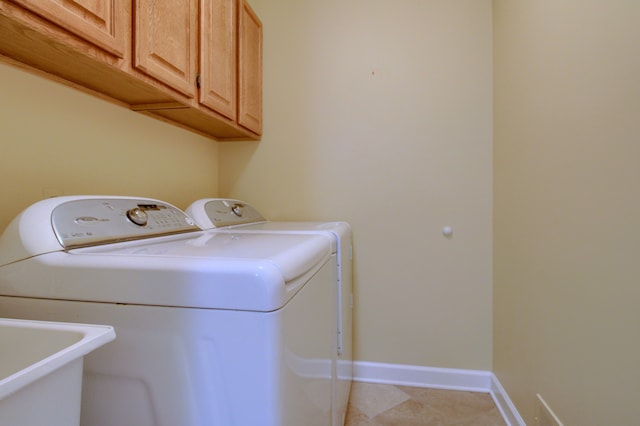 laundry room with separate washer and dryer, baseboards, a sink, and cabinet space