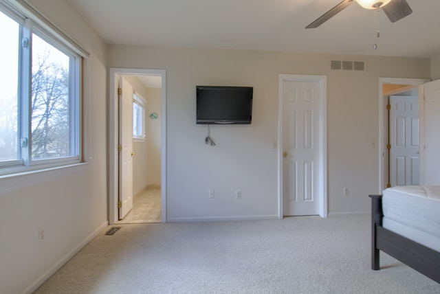 unfurnished bedroom with light carpet, visible vents, and baseboards