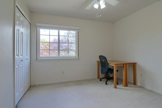 carpeted office with ceiling fan, baseboards, and visible vents