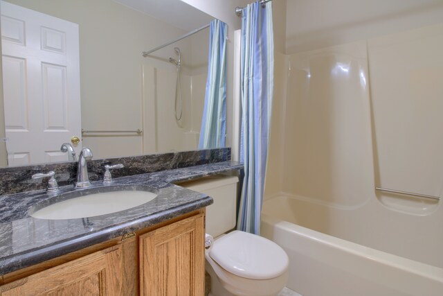 bathroom featuring shower / bath combination with curtain, vanity, and toilet