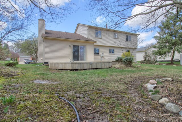 back of property with a yard and a chimney