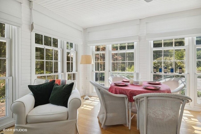 sunroom / solarium featuring wood finished floors