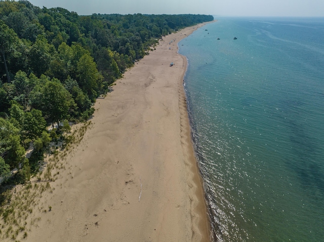 birds eye view of property featuring a view of the beach and a water view