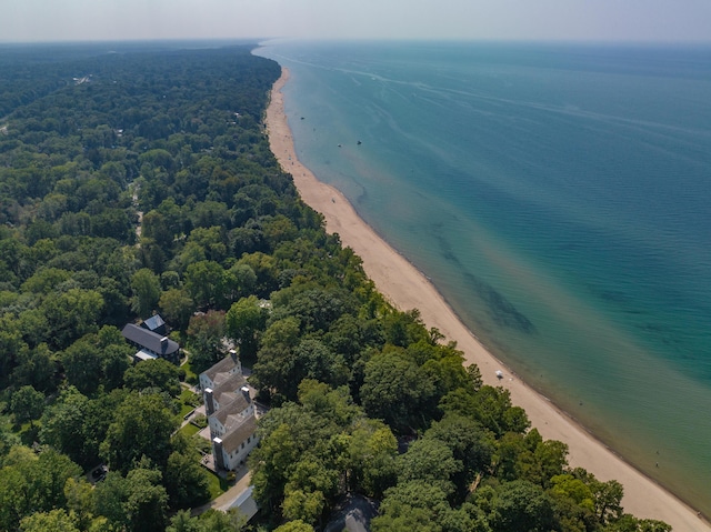 bird's eye view featuring a view of the beach, a water view, and a view of trees