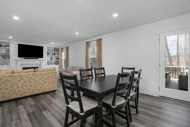 dining area with recessed lighting, a wealth of natural light, and dark wood-type flooring