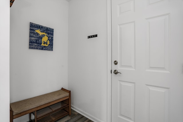 interior space featuring baseboards and wood finished floors