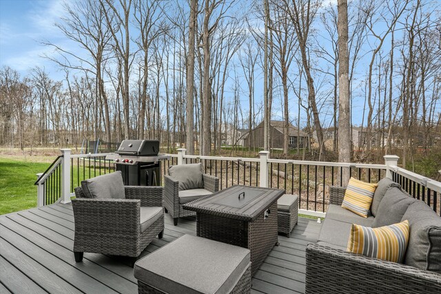 wooden deck with an outdoor living space and a grill