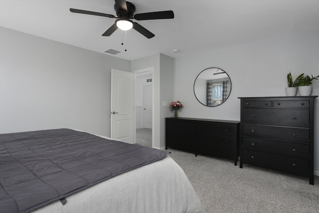carpeted bedroom with ceiling fan and visible vents