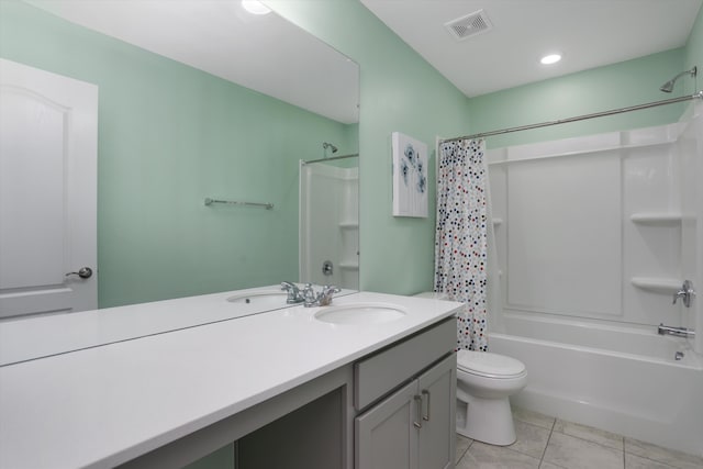 bathroom featuring visible vents, vanity, tile patterned flooring, shower / bath combo with shower curtain, and toilet