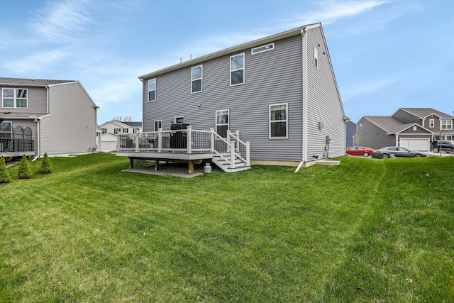rear view of house with a lawn and a deck