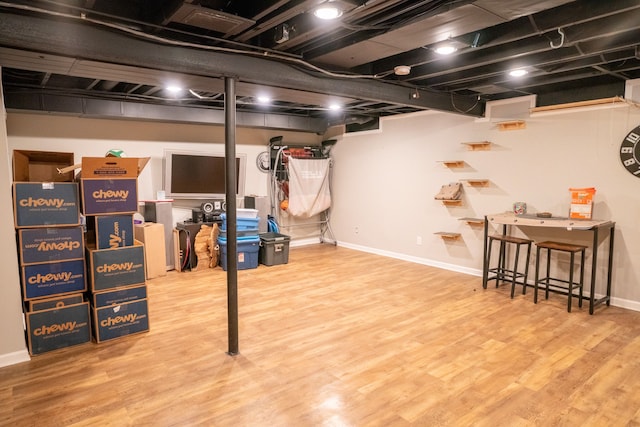 finished below grade area with wood finished floors and baseboards
