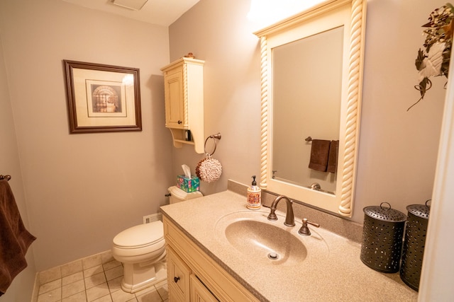 half bath featuring baseboards, toilet, tile patterned flooring, and vanity
